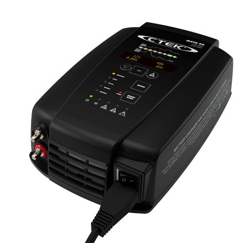 CTEK MXTS 40 40 amp battery charger in use, powering a vehicle battery in an Indian garage setting