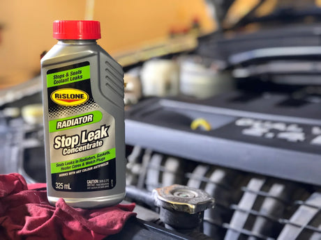 Rislone Stop leak concenrate on a car engine with the raditor cap visible