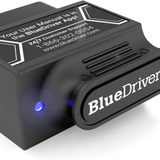 Person using BlueDriver OBD2 scanner on car dashboard in India, best tool for full system diagnostics and clearing codes