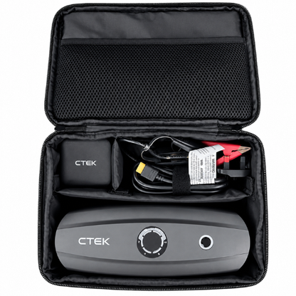 Black CTEK portable air compressor shown inside its open zippered carrying case, with accessories including a charger, cable, and red/black clamps visible.