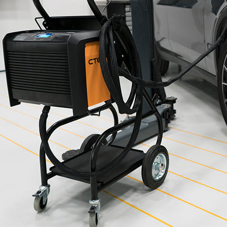 CTEK Pro 120 automatic charger powering a car battery in an Indian garage, ideal for AGM, GEL & Lead-Acid vehicles