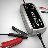 CTEK MXS 7.0 12V AGM charger size reference beside common objects, compact design ideal for Indian vehicle batteries