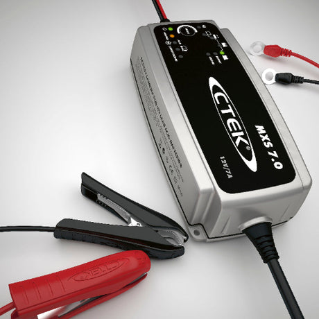 CTEK MXS 7.0 12V AGM charger size reference beside common objects, compact design ideal for Indian vehicle batteries