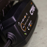 Ctek nxt 5 12v smart battery charger with black casing and orange and white illuminated adaptive charging indicators