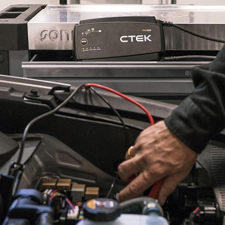 Black ctek pro 25s 12v 25a battery charger with digital display and red and black cables for lithium support
