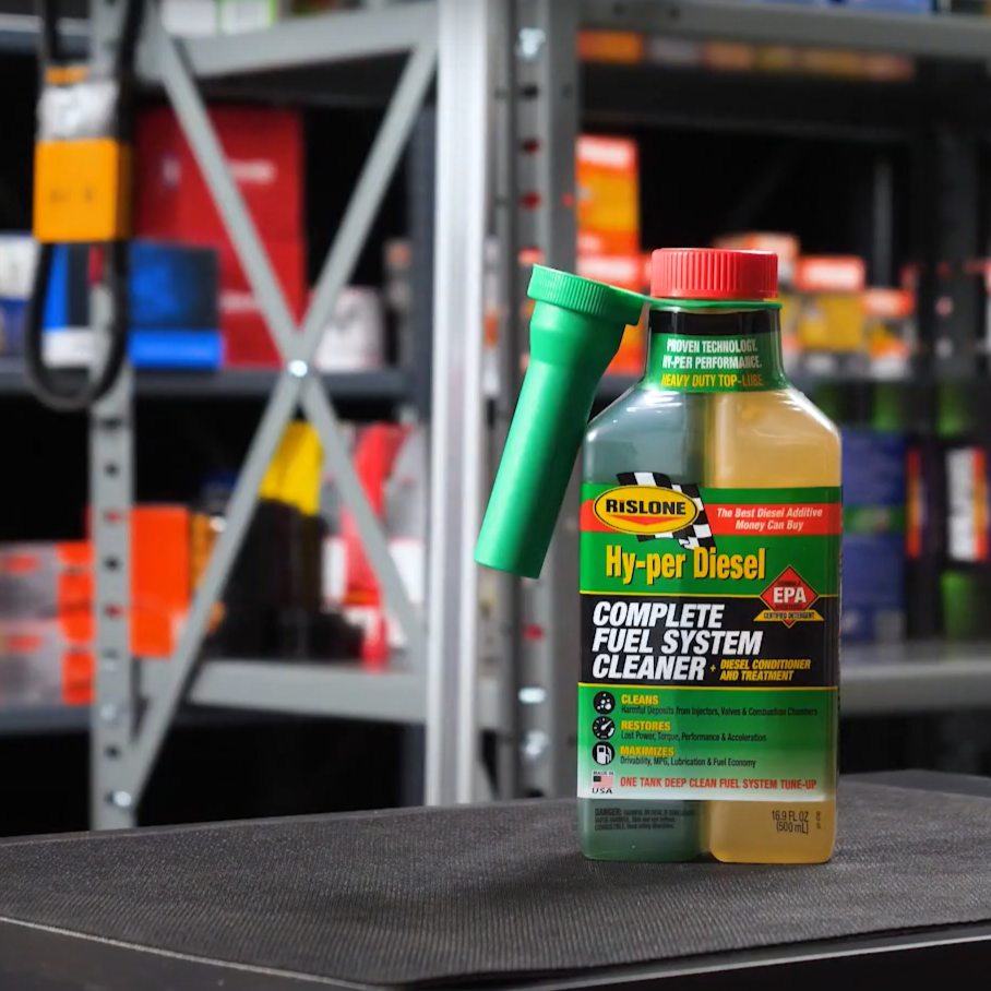 Hyper Diesel Complete Fuel System Treatment on a black surface with shelves and products in the background.