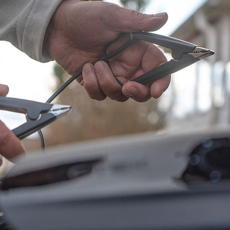 Black metal jumper cables with insulated handles for the CTEK CS ONE 12V smart battery charger with app control