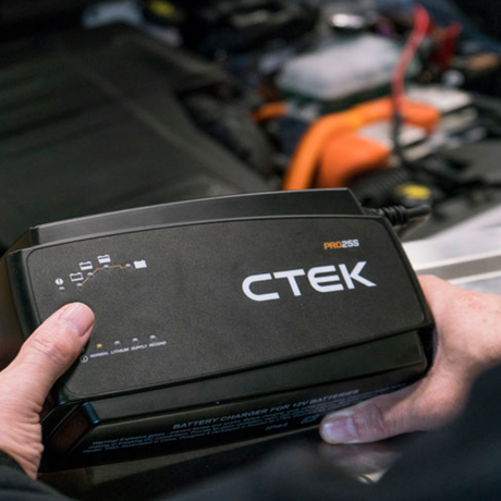 Black CTEK Pro 25S 12V 25A battery charger with white branding and indicator lights for lithium support and workshop use