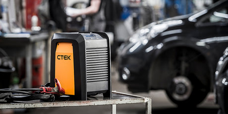 Orange and black ctek pro 60 12v 60a charger with sleek rectangular design for lead-acid and lifepo4 batteries